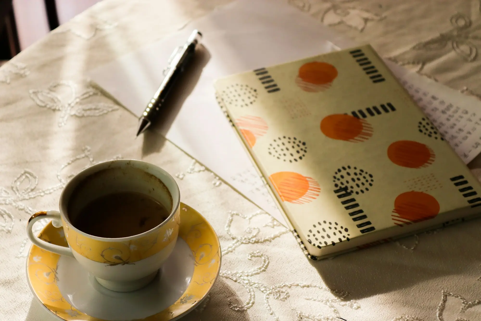 Coffee cup and notebook on a table, planning how to get a business loan